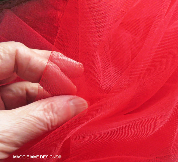 Yards of red tulle were used to create a "nest" around the entire hat for the trims.