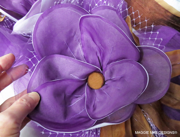 Three purple silk organza Marguerites lined with white silk organza adorn the "Big Brown" hat