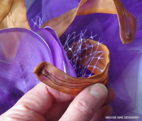 Chestnut silk organza "feathers" adorn the "Big Brown" hat